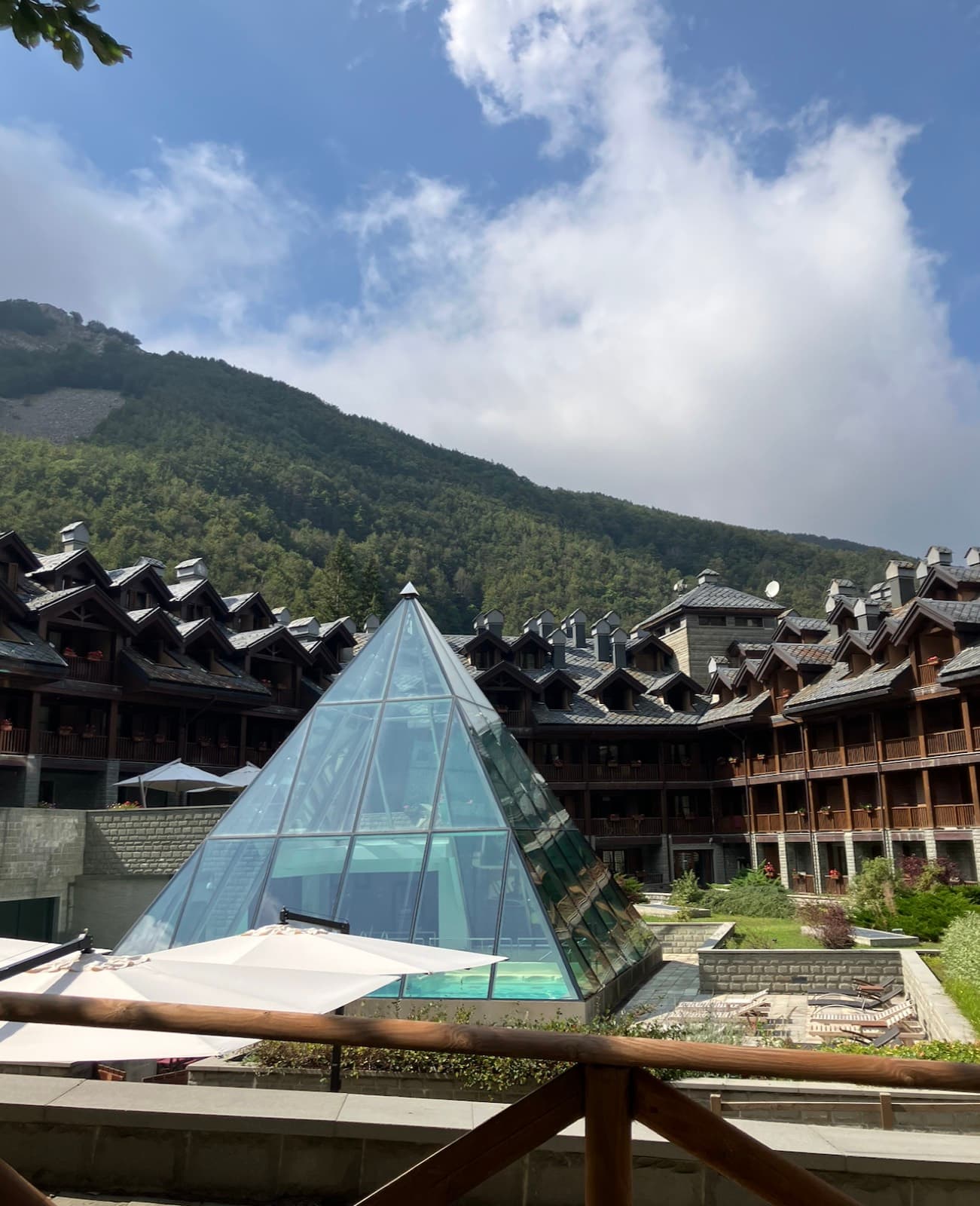 The hotel in the Val di Luce with its glass pyramid over the pool, under the Apennine ridge