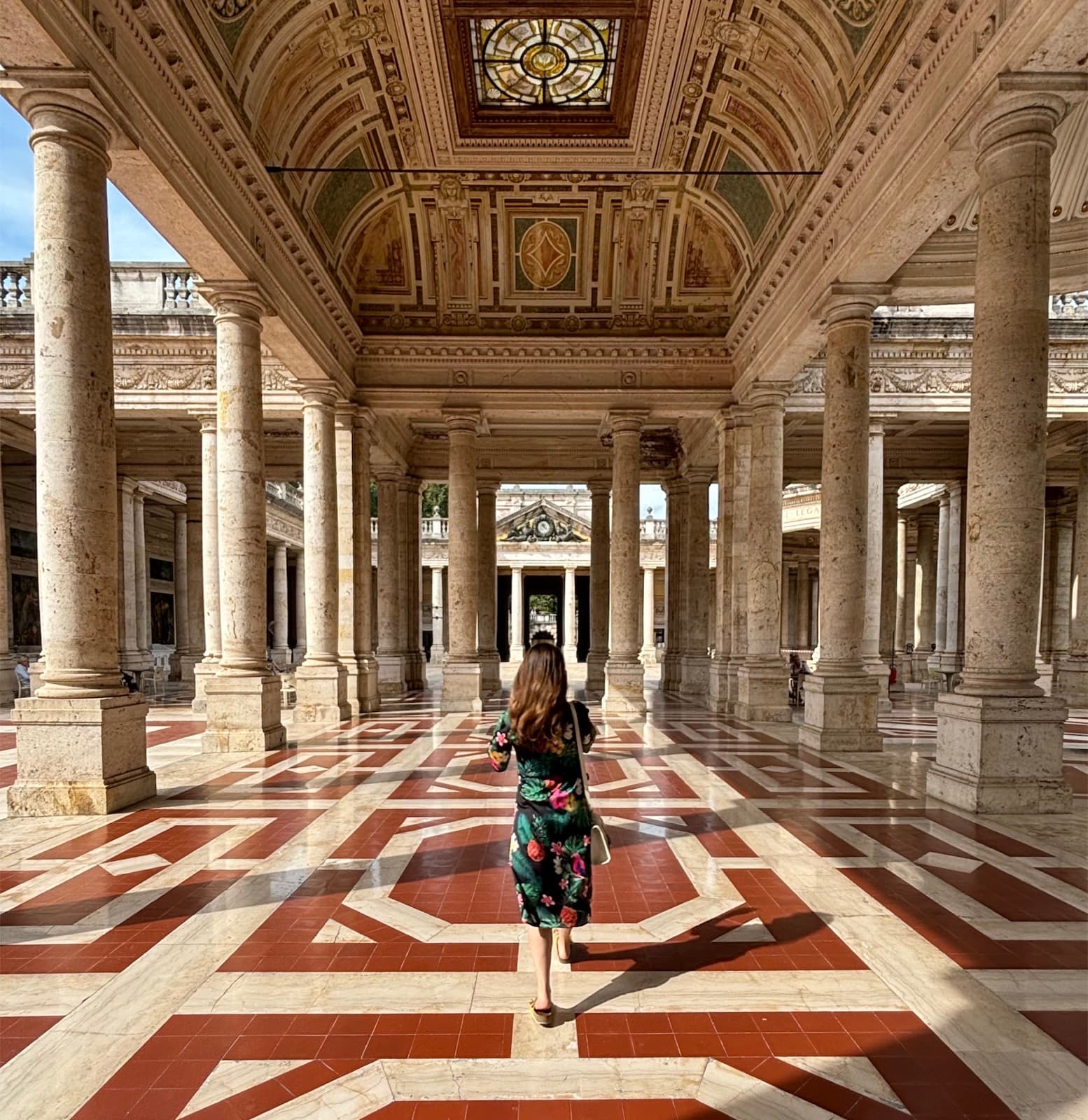 The marble colonnade of the Tettuccio baths, patterned floor, almost nobody in it